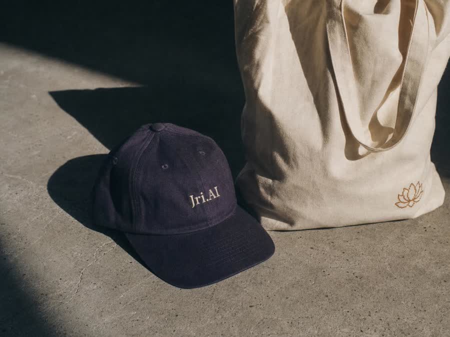 Ink-violet cap and ecru canvas tote in afternoon light