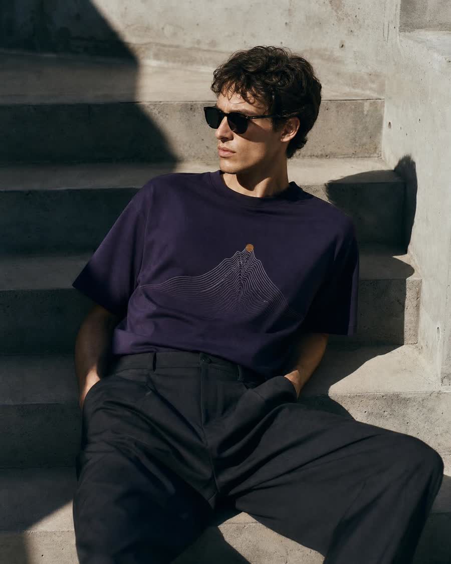 Ink-violet tee with contour-line peak print